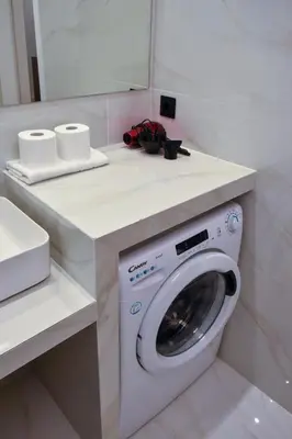 a bathroom with a washing machine and a sink at Cozy apartment in Pireus in Piraeus