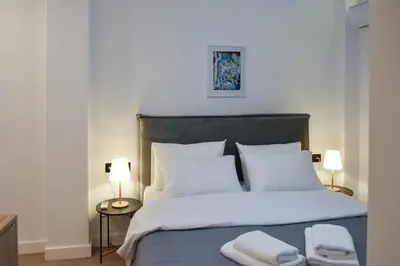 a bedroom with a bed with two towels on it at Cozy apartment in Pireus in Piraeus