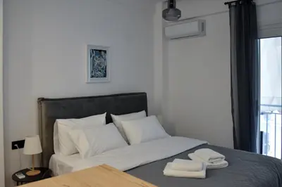 a bedroom with a bed with two towels on it at Cozy apartment in Pireus in Piraeus