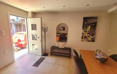 a dining room with a table and a mirror at 'Home Downtown' in Athens