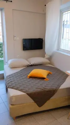 a bedroom with two beds with a yellow pillow on it at Athens studio with a view in Athens