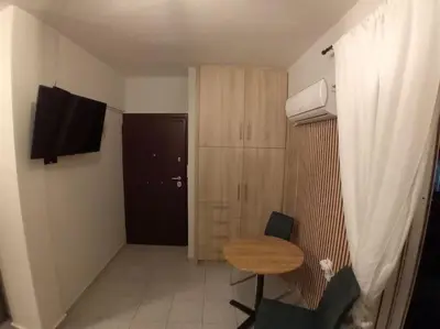 a small room with a small table and a door at Athens studio with a view in Athens