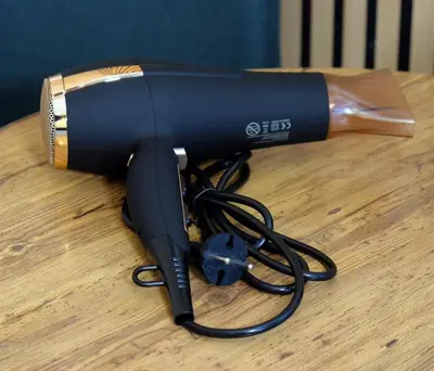 a blow dryer sitting on a wooden table at Athens studio with a view in Athens