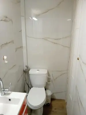 a white bathroom with a toilet and a sink at Athens studio with a view in Athens
