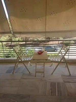 a table and chairs in a room with a window at Athens Riviera Beach Retreat in Athens