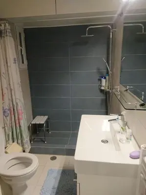 a bathroom with a toilet and a sink and a shower at Athens Riviera Beach Retreat in Athens