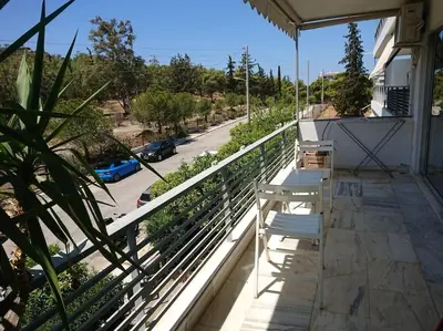 a balcony with two benches and a view of a street at Athens Riviera Beach Retreat in Athens