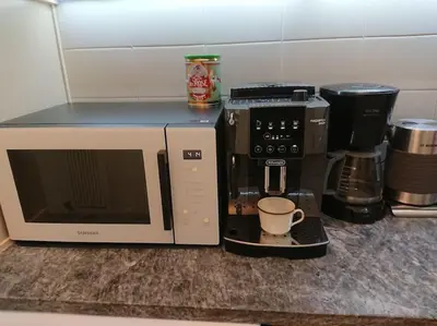 a microwave and a coffee maker on a counter at Athens Riviera Beach Retreat in Athens