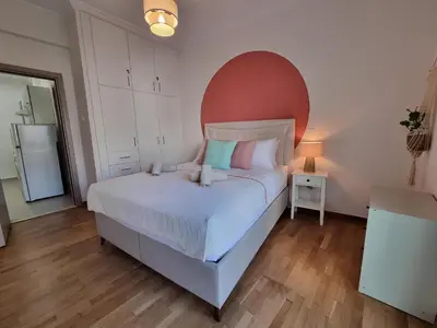a bedroom with a large bed with a red headboard at Athens Stylish Renovated 62sqm Apartment for Families & Couples with Balcony in Quiet Area near City Center in Athens