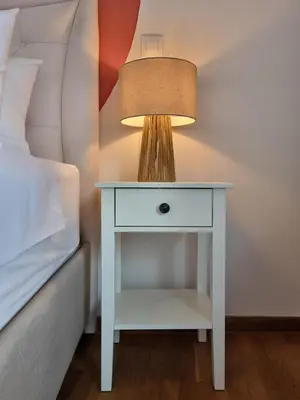a white nightstand with a lamp on it next to a bed at Athens Stylish Renovated 62sqm Apartment for Families & Couples with Balcony in Quiet Area near City Center in Athens