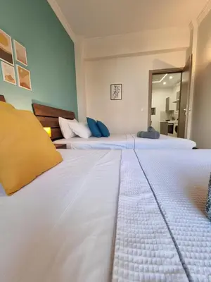 two white beds in a room with a mirror at Athens Stylish Renovated 62sqm Apartment for Families & Couples with Balcony in Quiet Area near City Center in Athens