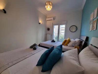 a room with three beds and a couch in it at Athens Stylish Renovated 62sqm Apartment for Families & Couples with Balcony in Quiet Area near City Center in Athens