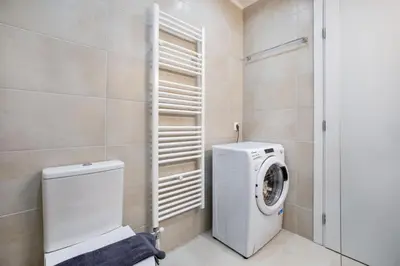 a bathroom with a washer and dryer in it at Glimmer 2-Bedroom Apartment in Athens in Athens