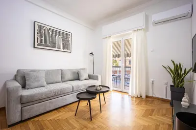 a living room with a couch and a table at Upper House in Athens