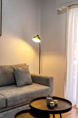 a living room with a couch and a table at Upper House in Athens