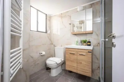 a bathroom with a toilet and a sink at Upper House in Athens