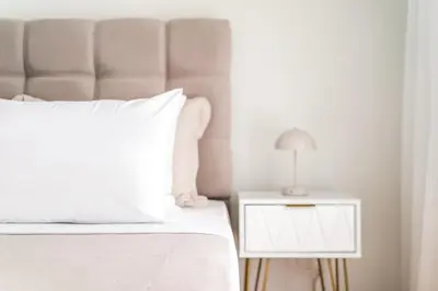 a bedroom with a bed and a nightstand with a lamp at Upper House in Athens