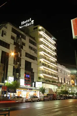 a hotel with a sign on top of a building at Noufara in Piraeus