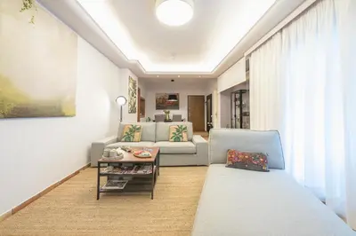 a living room with a couch and a table at Shoreline Athens Riviera in Athens