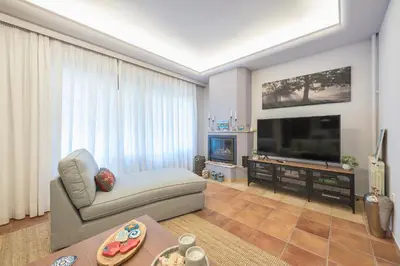 a living room with a couch and a flat screen tv at Shoreline Athens Riviera in Athens