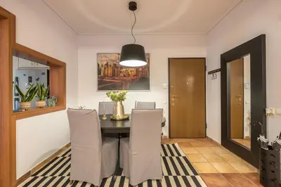 a dining room with a table and chairs at Shoreline Athens Riviera in Athens