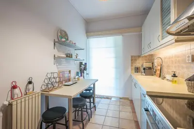 a kitchen with a counter and stools in it at Shoreline Athens Riviera in Athens
