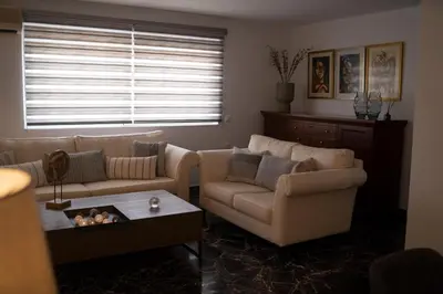 a living room with a couch and a table at Athens Horizon in Athens