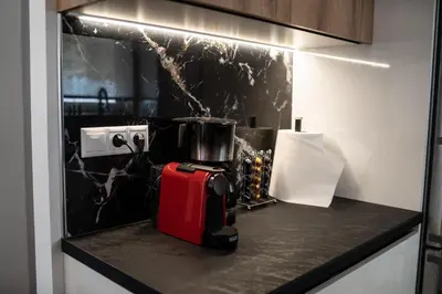 a red suitcase sitting on a counter in a kitchen at Athens Horizon in Athens
