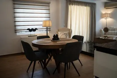 a dining room table and chairs in a room at Athens Horizon in Athens
