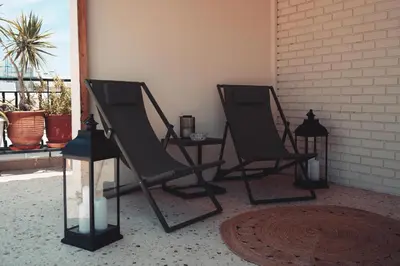 two black chairs sitting next to a window at Athens Horizon in Athens