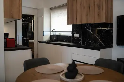 a kitchen with a wooden table and a kitchen with a sink at Athens Horizon in Athens