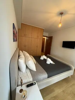 a bedroom with a large bed with white pillows at Elliniko Luxury Apartment in Athens