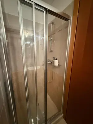 a shower with a glass door in a bathroom at Elliniko Luxury Apartment in Athens