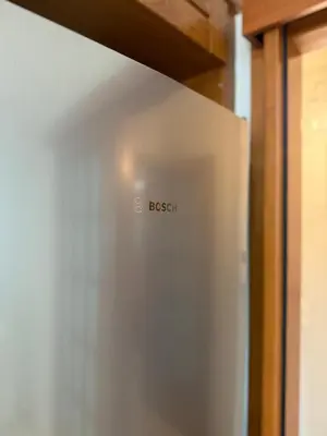 a stainless steel refrigerator with the word bosch on it at Elliniko Luxury Apartment in Athens