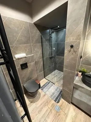a bathroom with a shower and a toilet and a sink at My house apartment jp in Athens