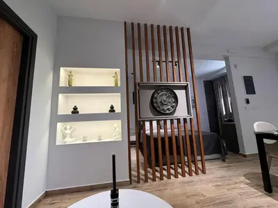 a room with shelves and a clock on a wall at My house apartment jp in Athens