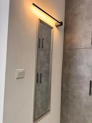 a mirror hanging on a wall in a bathroom at My house apartment jp in Athens