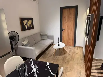 a living room with a couch and a table at My house apartment jp in Athens