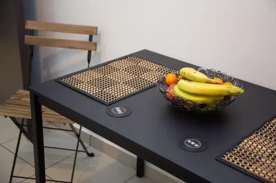 a bowl of fruit on a table with a chair at Angel - Cozy, renovated, studio in Athens heart in Athens