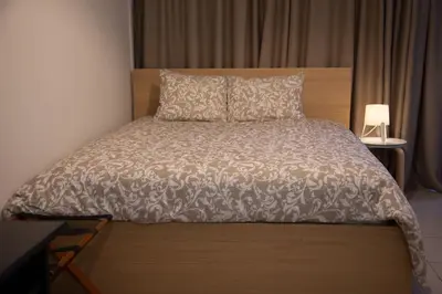 a bedroom with a large bed with a wooden headboard at Angel - Cozy, renovated, studio in Athens heart in Athens