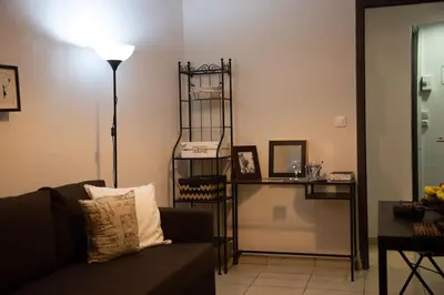 a living room with a couch and a lamp at Angel - Cozy, renovated, studio in Athens heart in Athens