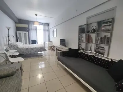a large living room with a bed and a couch at Angel's Yard in Athens Heart in Athens