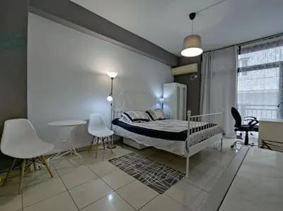 a bedroom with a bed and a table and chairs at Angel's Yard in Athens Heart in Athens