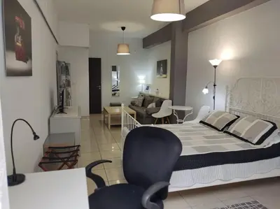a bedroom with a bed and a living room at Angel's Yard in Athens Heart in Athens