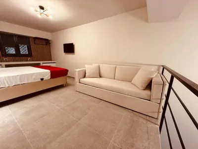 a bedroom with a bed and a couch in it at Loft Athens 1 - 55m2 in Athens