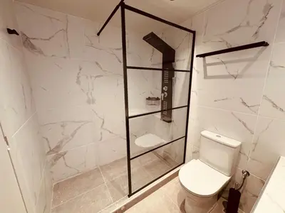 a white bathroom with a toilet and a shower at Loft Athens 1 - 55m2 in Athens