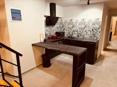 a kitchen with a black counter top in a room at Loft Athens 1 - 55m2 in Athens