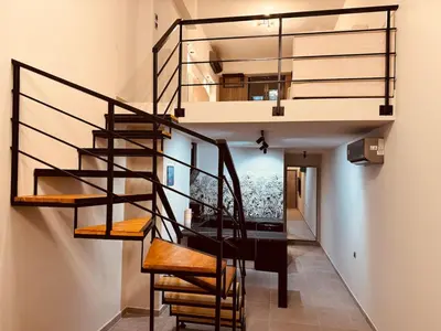 a spiral staircase leading up to a loft apartment at Loft Athens 1 - 55m2 in Athens