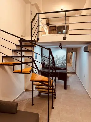 a spiral staircase in a house with a living room at Loft Athens 1 - 55m2 in Athens