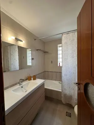 a bathroom with a tub and a sink and a bath tub at La Maison in Áyios Nikólaos